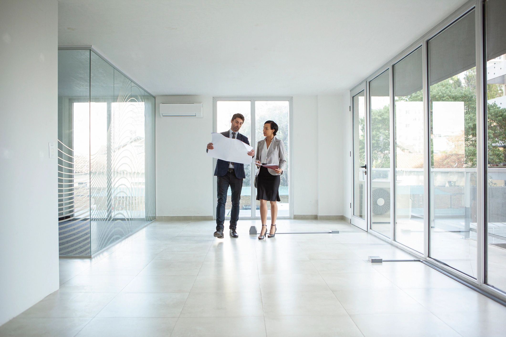 Professionals reviewing property plans and documents