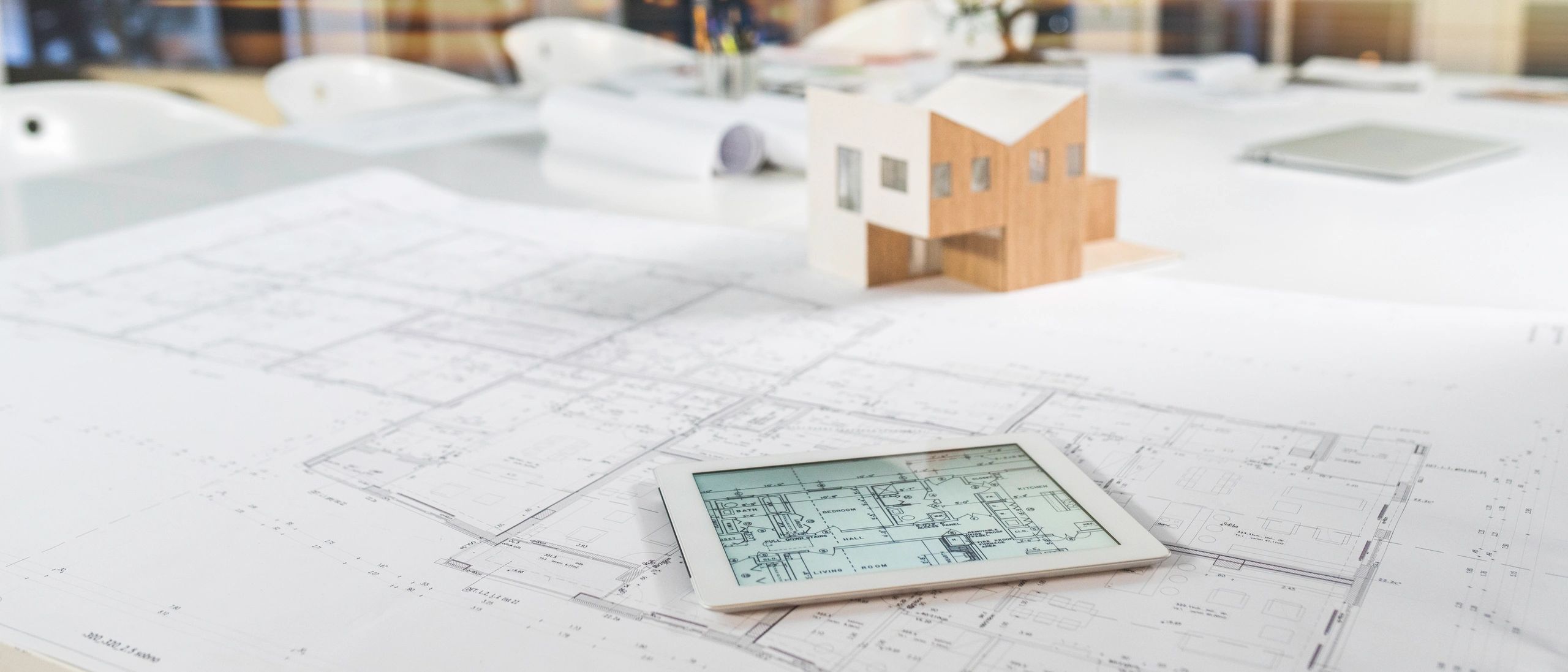 Digital tablet with property blueprint and model house